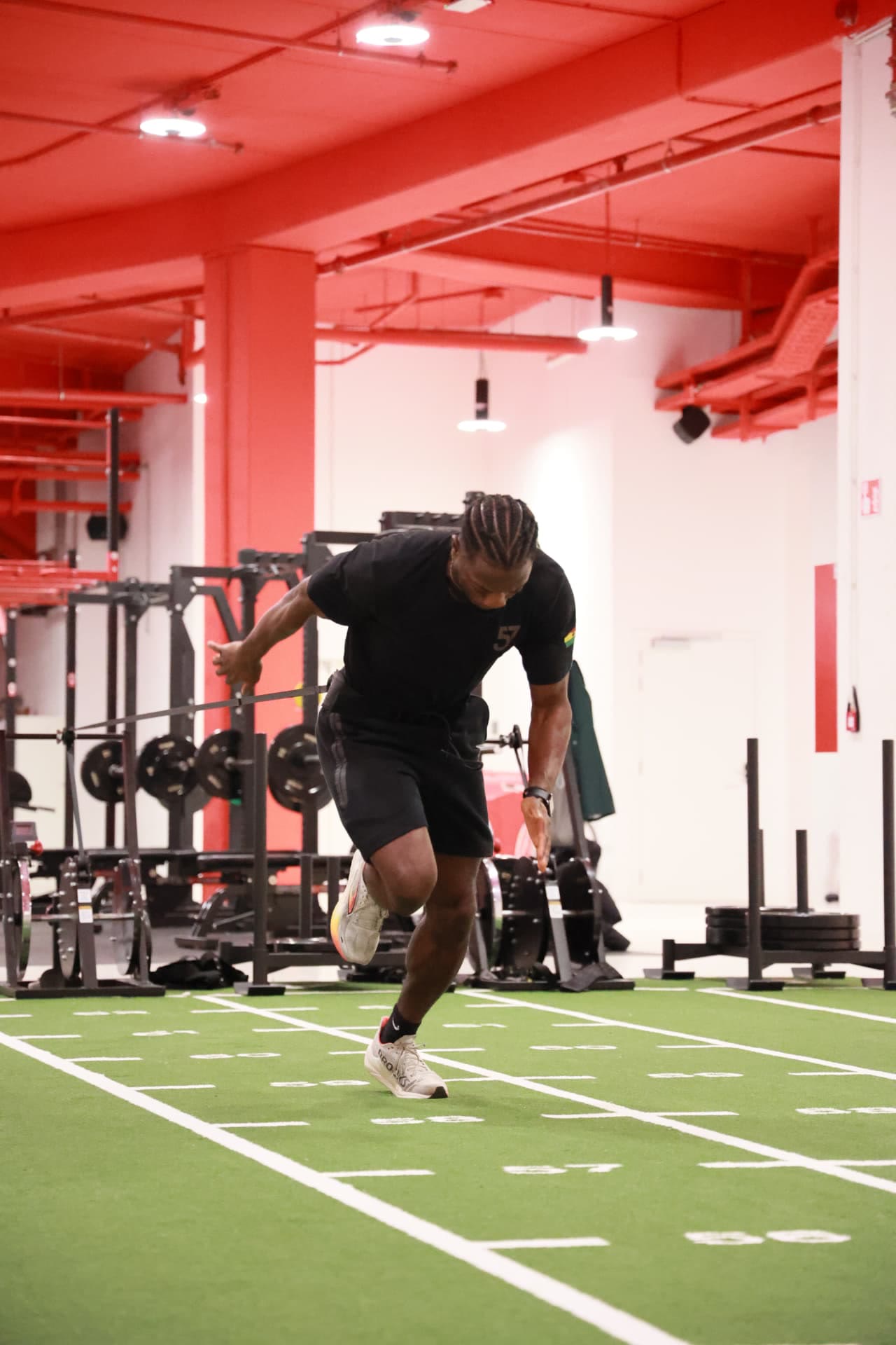 Athlete performing a band-resisted sprint drill