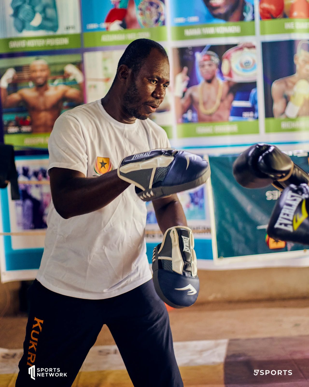 Coach holding pads for a boxer